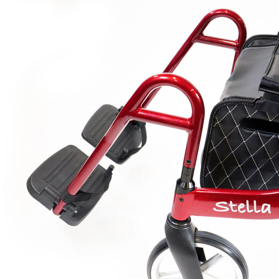 Red rollator footrest with black seat and 'Stella' branding on a white background