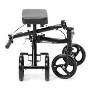 Black knee walker with gray cushion on a white background