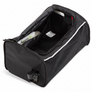 Black travel bag with a white interior, containing a bottle of shampoo.