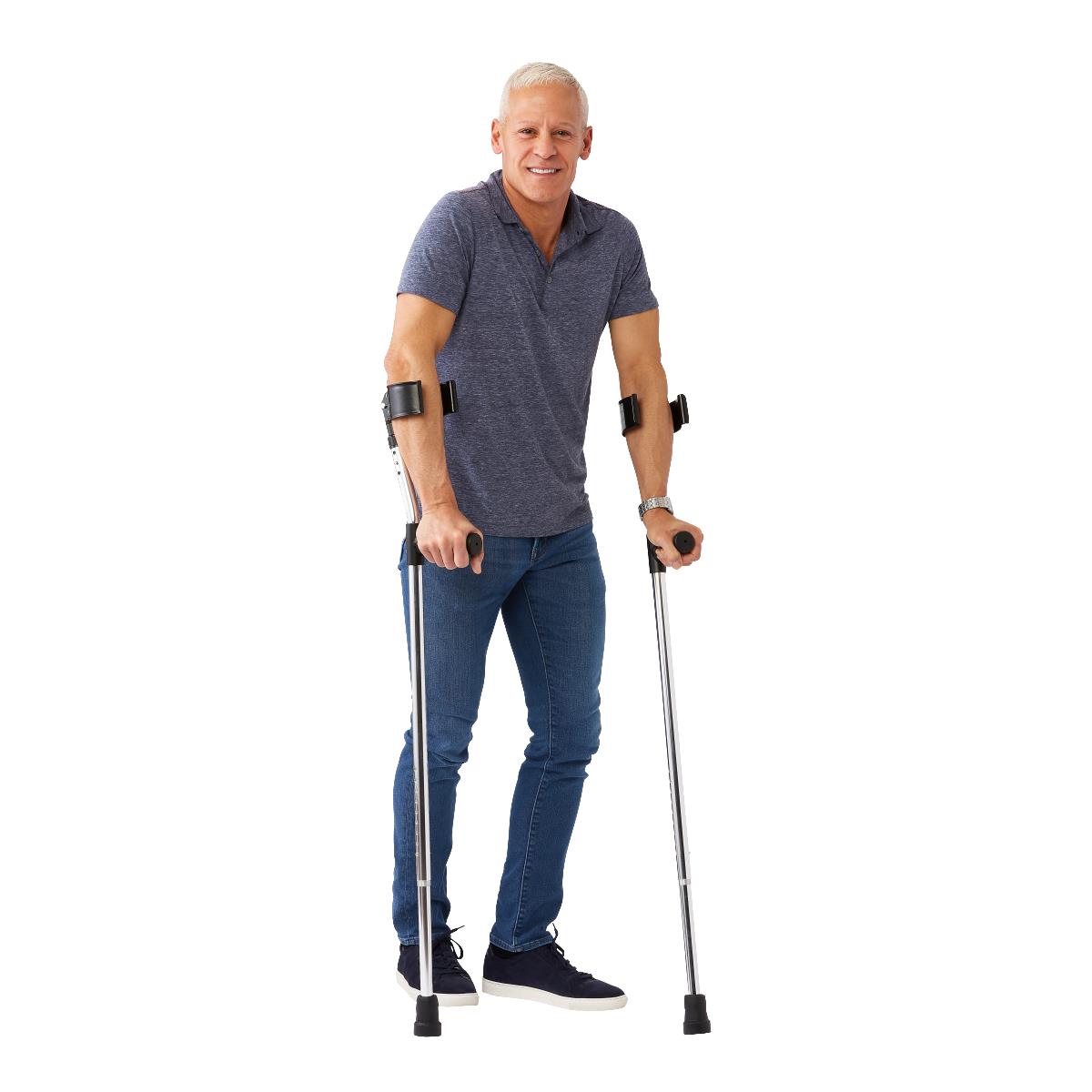 Man using crutches on a white background