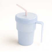 Light blue tumbler with a straw on a white background