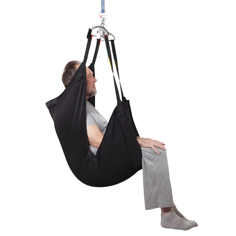 Person using a black medical sling chair on a white background