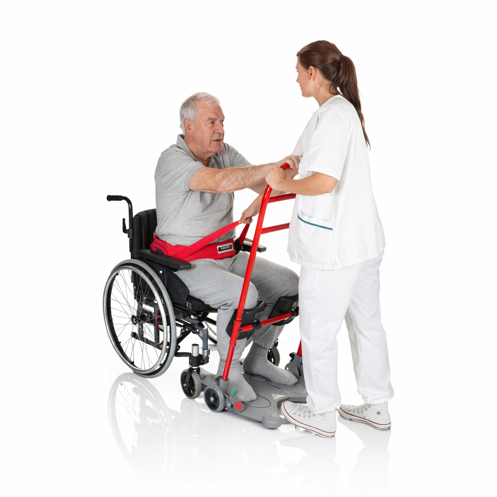 Person using a wheelchair with a red transfer aid, assisted by a healthcare professional on a white background